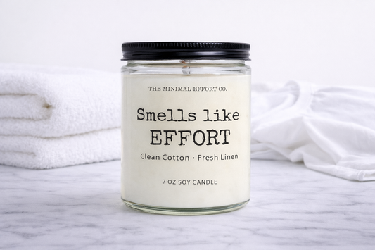 Candle with 'Smells like Effort' label on a white background