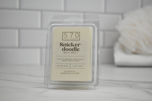 Snickerdoodle wax melt packaging on a tiled bathroom counter