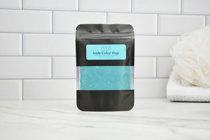 Black packaging with a blue label on a white tiled wall background