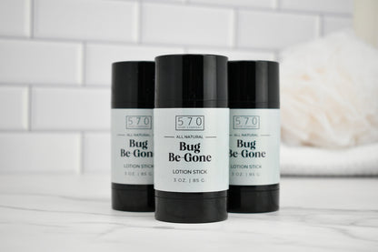 Three 'Bug Be Gone' lotion sticks with black and white labels on a white surface.