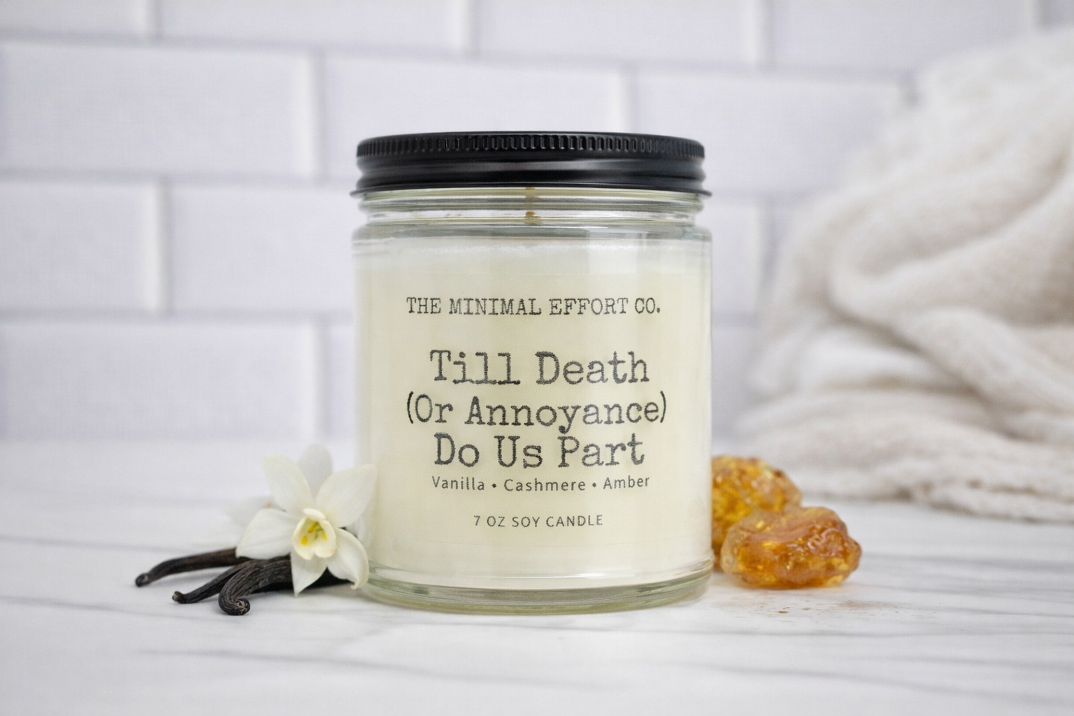 Candle with label 'Till Death (Or Annoyance) Do Us Part' from The Minimal Effort Co. on a white background.