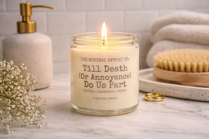 Candle labeled 'Till Death (Or Annoyance) Do Us Part' by The Minimal Effort Co. on a bathroom counter.