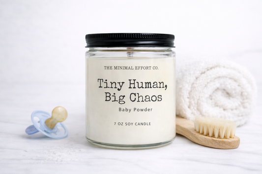 Baby powder candle with pacifier, towel, and brush on a white background