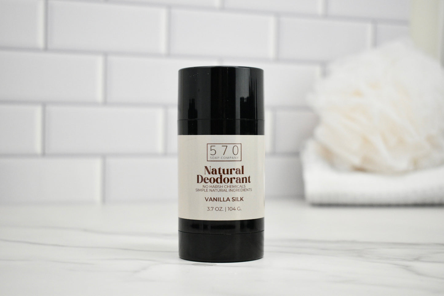 570 Natural Deodorant stick on a white surface with a blurred background