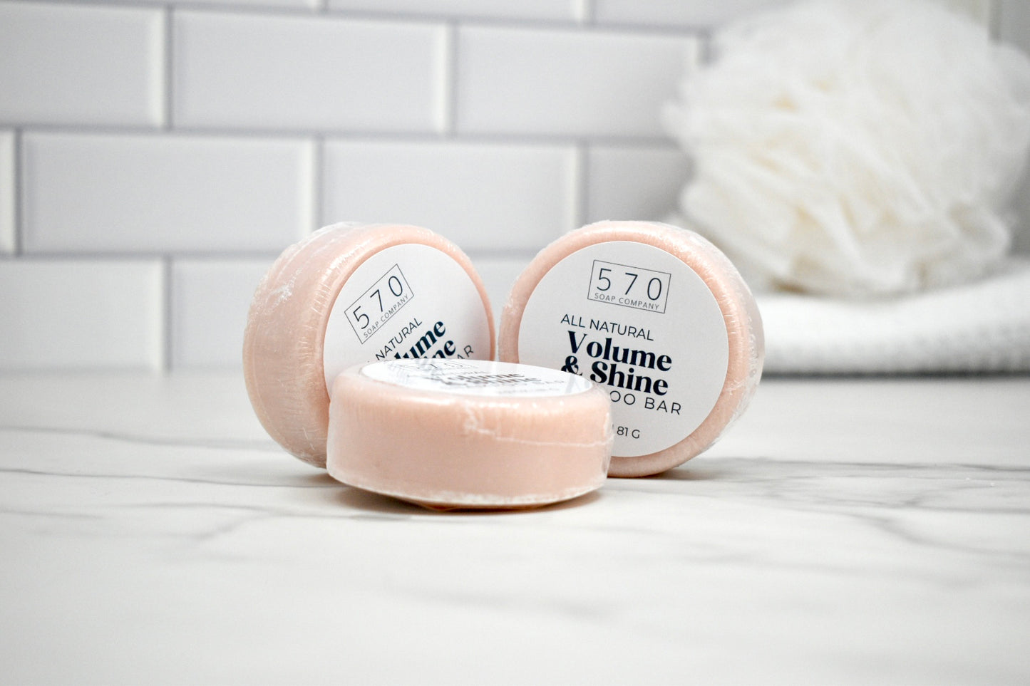 Three soap bars labeled '570' on a white surface with a blurred background