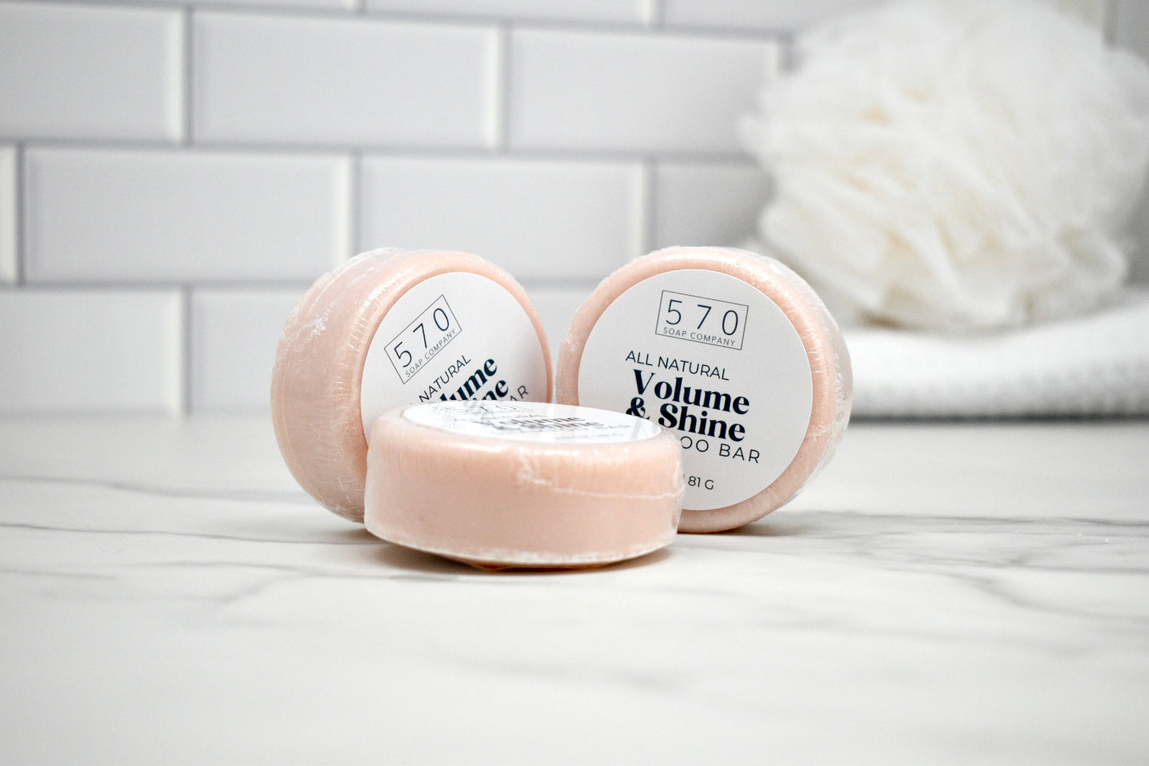 Three soap bars labeled '570' on a white surface with a blurred background