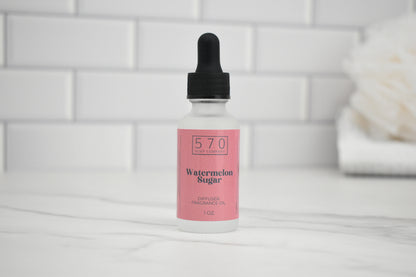 Bottle of 570 Watermelon Sugar perfume oil with a dropper on a white surface.