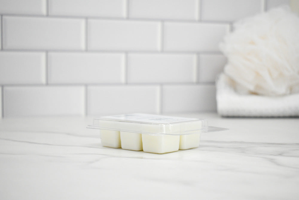 Wax melts on a white surface with a tiled wall in the background