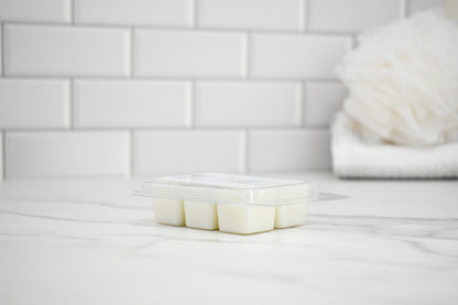 Wax melts on a white surface with a tiled wall in the background