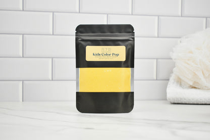 Black packaging with yellow content on a white surface and tiled wall background