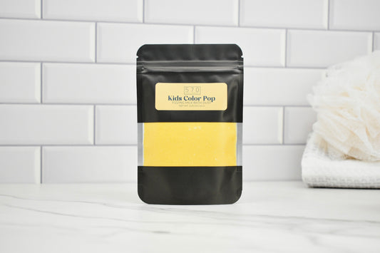 Black packaging with yellow content on a white surface and tiled wall background